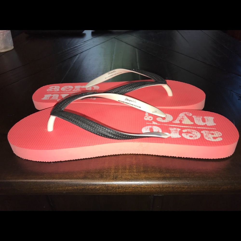 Pink, white and black flip flops